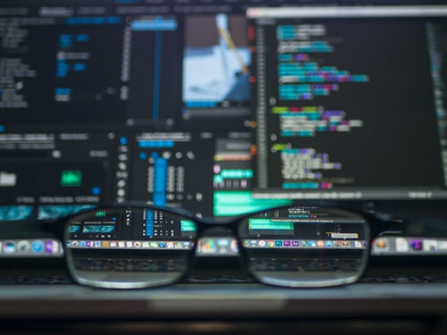 Developer typing code HTML CSS React PHP